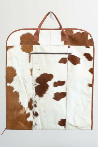 brown and white cowhide leather garment bag