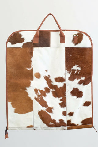 tan and white cowhide leather garment bag