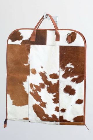 tan and white cowhide leather garment bag