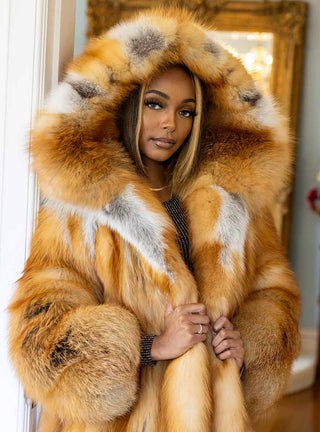 lady wearing a natural red fox fur stroller with a hood