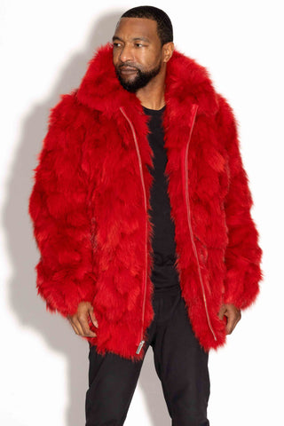 closer view of man wearing a red sectioned fox fur bomber jacket against a white backdrop