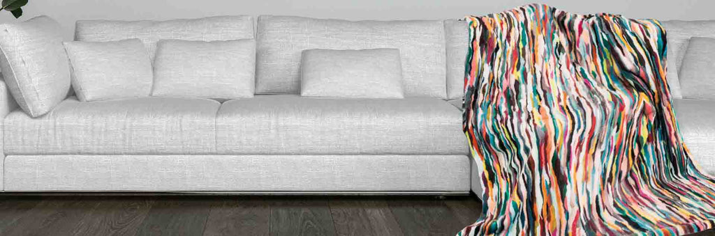 Multicolor Mink Fur Blanket draped over sofa - Shop our Fur Blankets Collection!