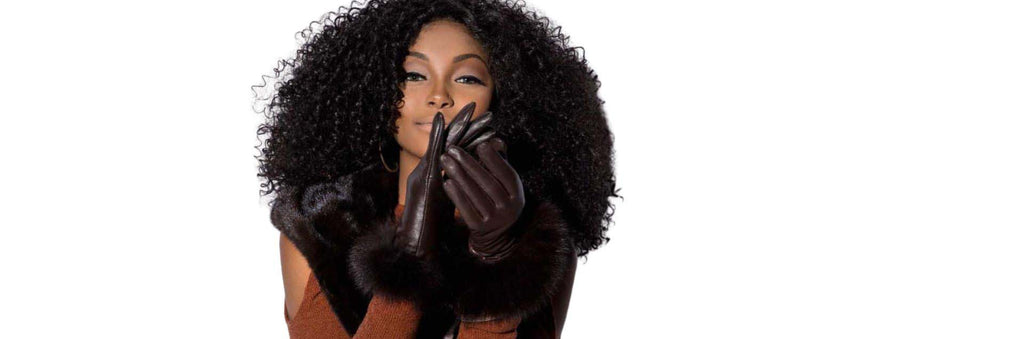 Woman wearing a pair of leather gloves with fur trim - Shop our Gloves Collection!