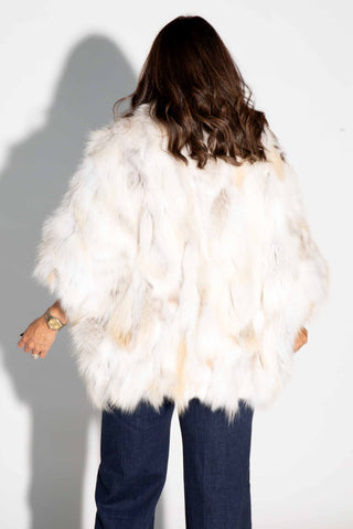 back of woman wearing a golden island sectioned fox fur capelet