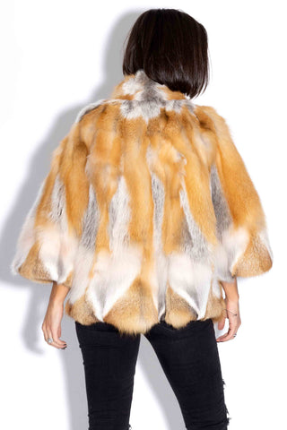 back of woman wearing a natural red fox fur capelet against a white backdrop