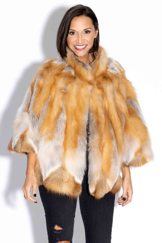 smiling woman wearing a natural red fox fur capelet against a white backdrop