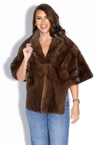 woman wearing a demi buff mink fur stole with shawl collar against a white backdrop