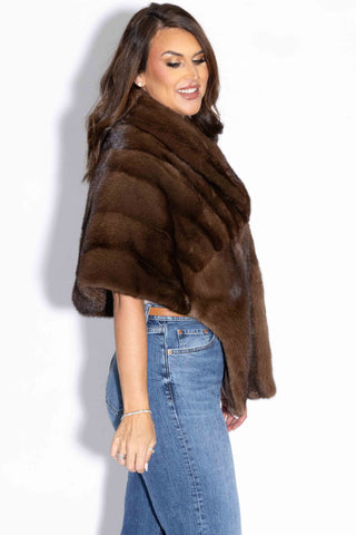 side profile of a woman wearing a demi buff mink fur stole with shawl collar against a white background