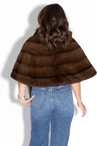 back of woman wearing a demi buff mink fur stole with shawl collar against a white background