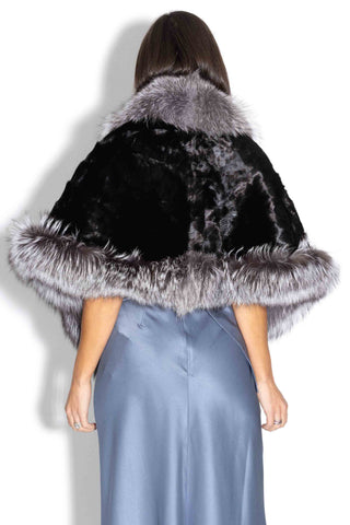 back of woman wearing a ranch chevron sectioned mink fur cape with silver fox fur trim against a white backdrop