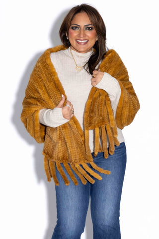 woman wearing a whisky knitted mink fur shawl against a white backdrop