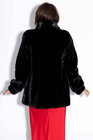 back of woman wearing a ranch mink fur jacket with shawl collar against a white backdrop