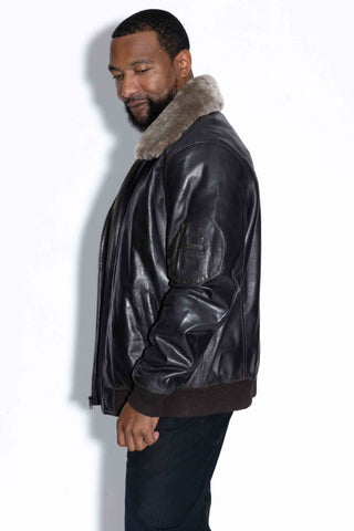 side profile of man wearing a leather bomber with wool collar against a white backdrop