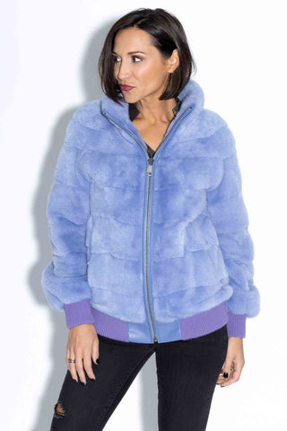 woman wearing a lilac nafa mink fur jacket against a white backdrop