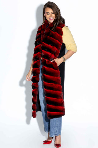 profile of smiling woman wearing a Long Red Chinchilla Fur and Italian Cashmere & Wool Blend Vest against a white backdrop