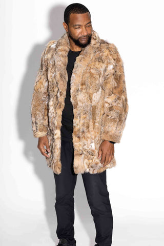 man wearing a sectioned bobcat fur stroller with shawl collar against a white backdrop