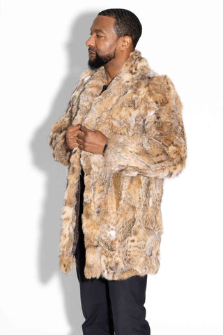man wearing a sectioned bobcat fur stroller against a white backdrop