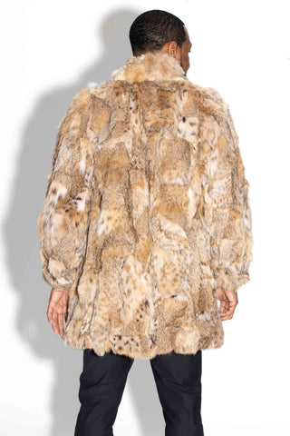 back of man wearing a sectioned bobcat fur stroller against a white backdrop