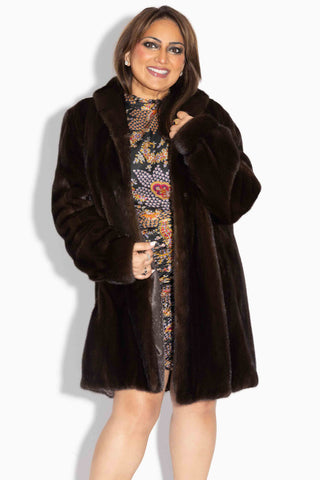 smiling woman wearing a mahogany female mink fur stroller 