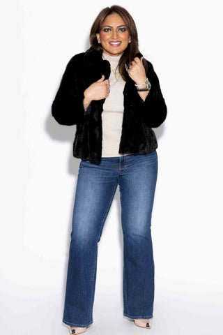 smiling woman wearing a Ranch Sectioned Mink Fur Bolero Jacket with Notch Collar against a white backdrop
