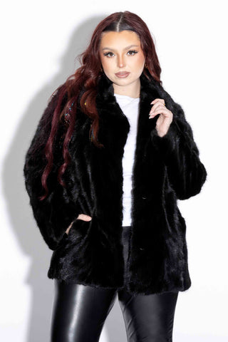 woman wearing a Ranch Sectioned Mink Fur Bolero Jacket with Notch Collar against a white backdrop