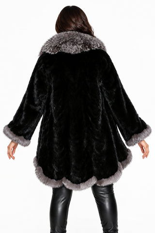 back of woman wearing a ranch sectioned mink fur stroller with silver fox fur trim against a white backdrop