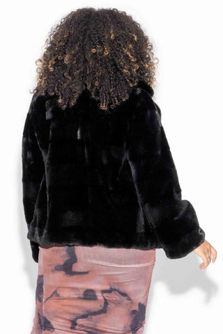 back of woman wearing a Sheared Sectioned Mink Fur Jacket with Notch Collar against a white backdrop
