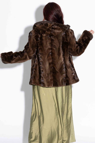 back of woman wearing a brown Reversible Sheared Sectioned Mink Fur Jacket with Hood against a white backdrop