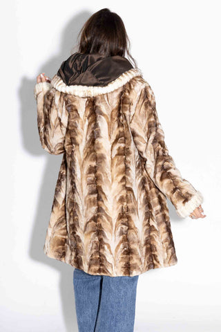 back of beige cross reversible sheared sectioned mink fur stroller with hood against a white backdrop