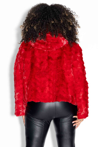 back of woman wearing a red chevron sectioned mink fur jacket with fox fur trim hood