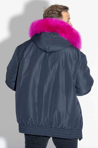 back of man wearing a pink multicolor reversible sectioned mink fur jacket, with navy cloth lining facing out, against a white backdrop