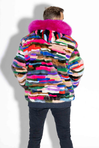 back of man wearing a pink multicolor sectioned mink fur jacket with pink fox fur trimmed hood