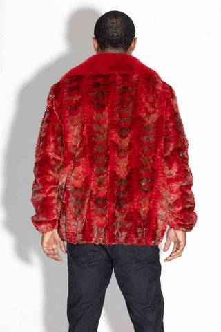 back of man wearing a red sheared sectioned mink fur bomber jacket with mink fur collar against a white backdrop