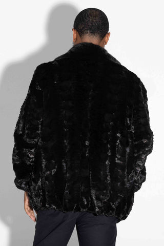 back of man wearing a ranch (black) sheared sectioned mink fur jacket with mink fur collar against a white backdrop