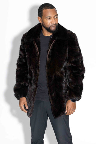 man wearing a mahogany sectioned mink fur bomber jacket with mink fur collar against a white backdrop