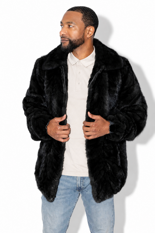 man wearing a ranch sectioned mink fur bomber jacket with mink fur collar against a white backdrop