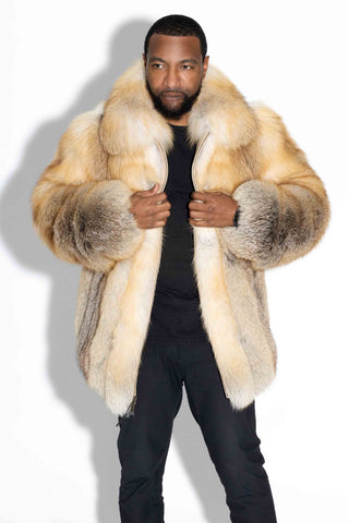 man wearing a custom-made full skin golden island fox fur bomber jacket, against a white backdrop