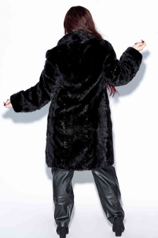 back of ranch sheared sectioned mink fur 3/4 coat against a white backdrop