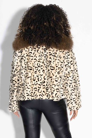 back of woman wearing a beige and ranch animal print sheared mink fur jacket with brown fox fur tux against a white backdrop