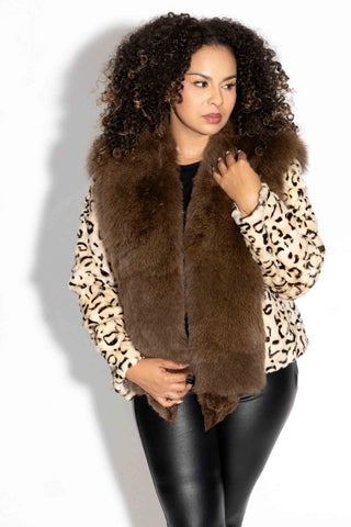 woman wearing a beige and ranch animal print sheared sectioned mink fur jacket with brown fox fur tux against a white backdrop