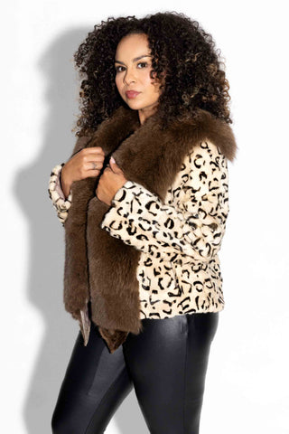 side profile of woman wearing a beige and ranch animal print sheared mink fur jacket with brown fox fur tux against a white backdrop