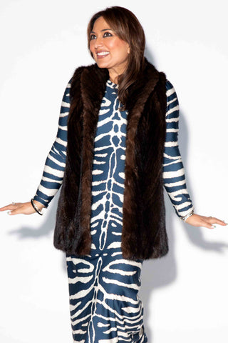 woman wearing a mahogany Chevron Sectioned Mink Fur Tails Vest with Shawl Collar