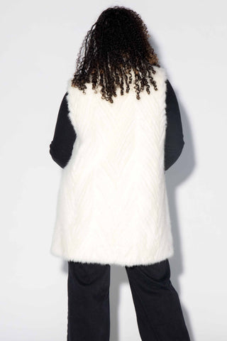 back of woman wearing a pearl Chevron Sectioned Mink Fur Tails Vest with Shawl Collar against a white backdrop
