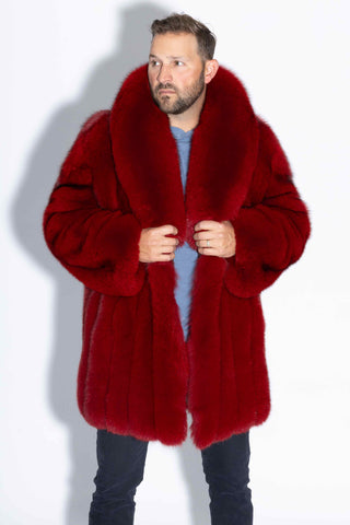man wearing a custom-made red fox fur stroller against a white backdrop