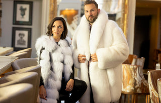 man and woman wearing white fox furs in a luxurious setting