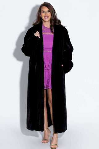 woman wearing a ranch mink fur coat against a white backdrop