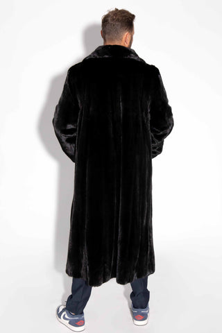 back of man wearing a blackglama ranch mink fur coat against a white backdrop