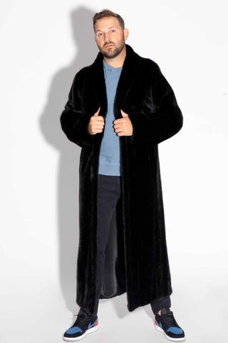 man wearing a men's custom-made full length ranch mink fur coat against a white backdrop