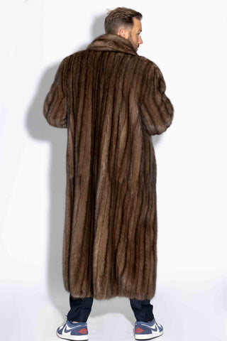 back of man wearing a custom-made men's full length sable fur coat against a white backdrop