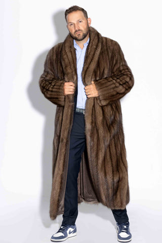man wearing a custom-made men's full length sable fur coat against a white backdrop